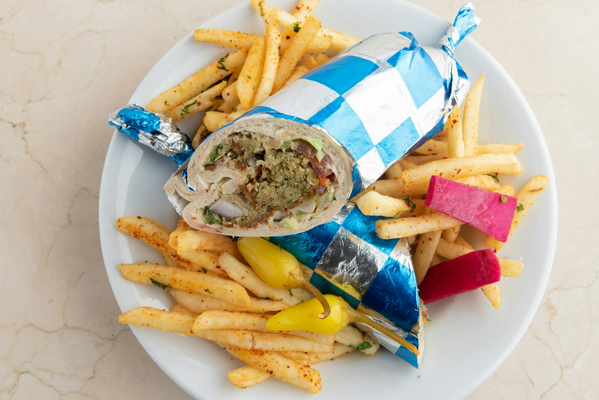A plate of french fries and a wrapper